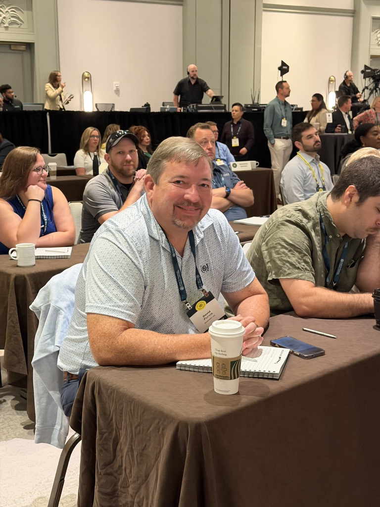 Smiling HTM members seated and ready for a live session